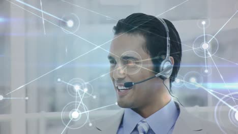 Animation-of-network-of-connections-over-businessman-using-phone-headsets