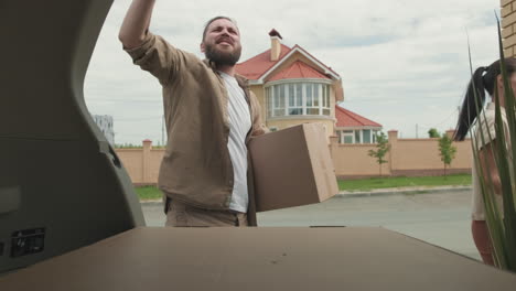 couple unpacking car and moving house