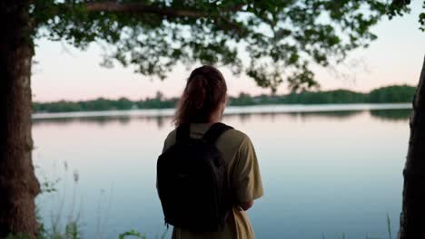 tourist taking photos of scenic view with peaceful lake during spring