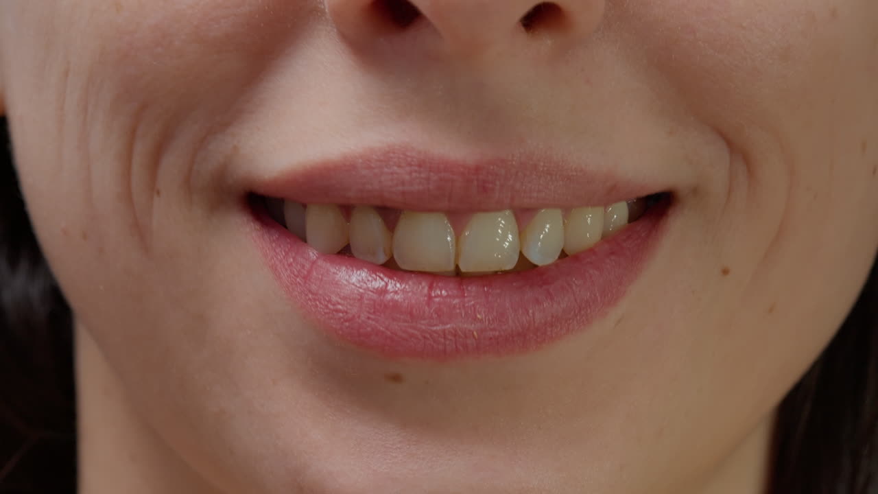 Macro shot portrait of cheerful woman smiling in front of camera