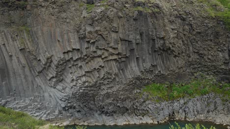 dramatic rock formations in the icelandic landscape of studlagil