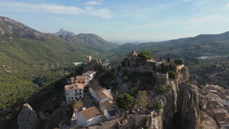 drone aproaching to the castle of guadalest, which is nestled on the top of a rock