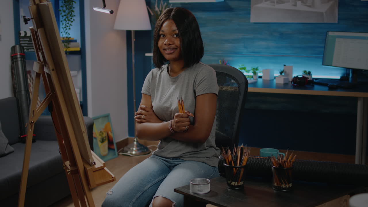 African american young woman holding colorful pencils