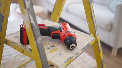 electric drill on a ladder