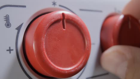 turning off a heater, a home appliance designed to warm a small room, by rotating its red knob back to the zero position