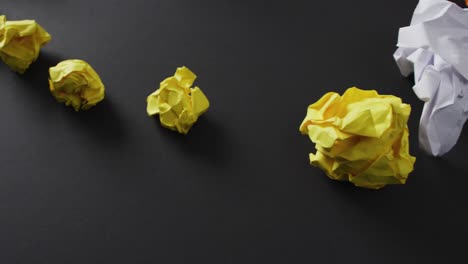 video of colorful paper balls and yellow plane on black background