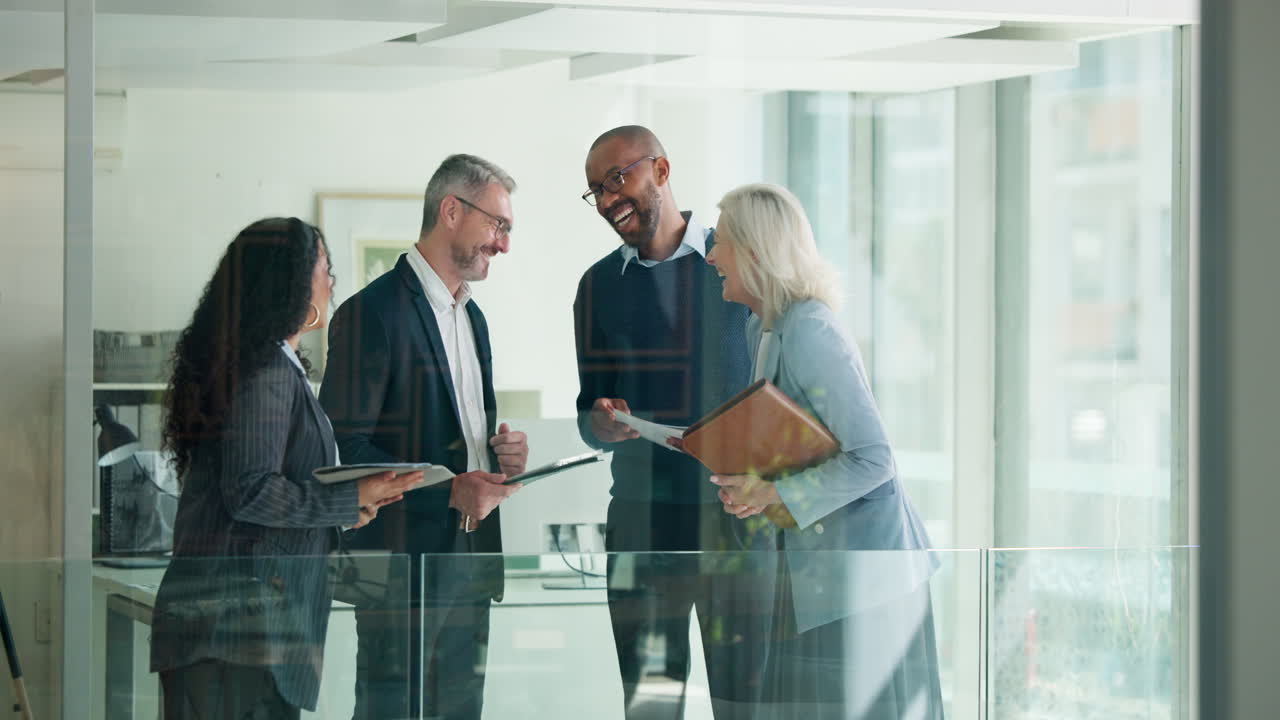 Diverse Business Colleagues Laughing During an Informal Office Discussion