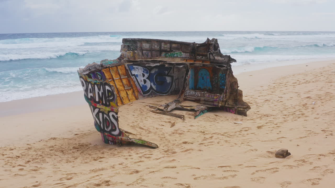 Aerial Shot of Shipwreck on Beach of Uluwatu, Bali, Indonesia. 4K Drone