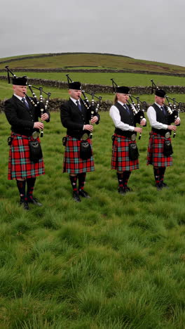 scottish bagpipers in traditional kilts performing outdoors