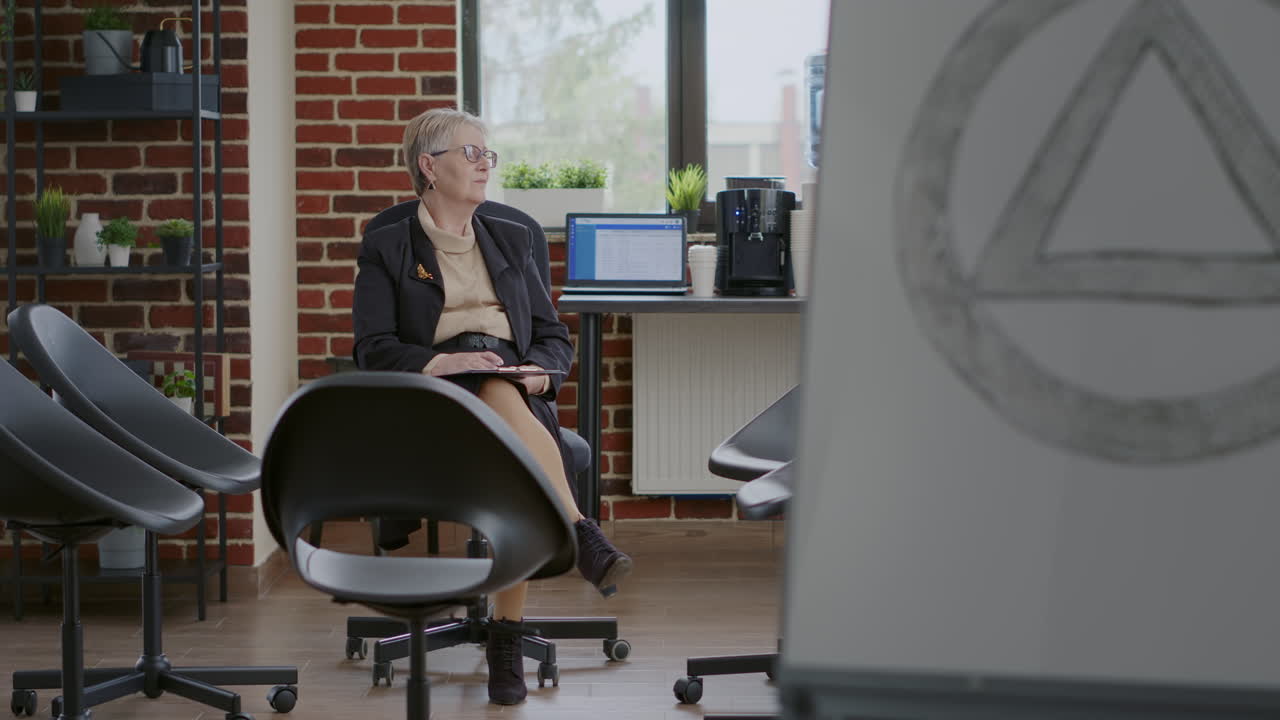 Psychologist sitting in circle with chairs and waiting on people at aa group meeting
