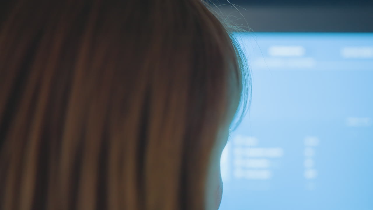 Close up rear view of operator tapping payment kiosk screen, soft focus, finger pressing buttons on touchscreen, blue glow, contactless self service interface, modern cashless transaction indoor