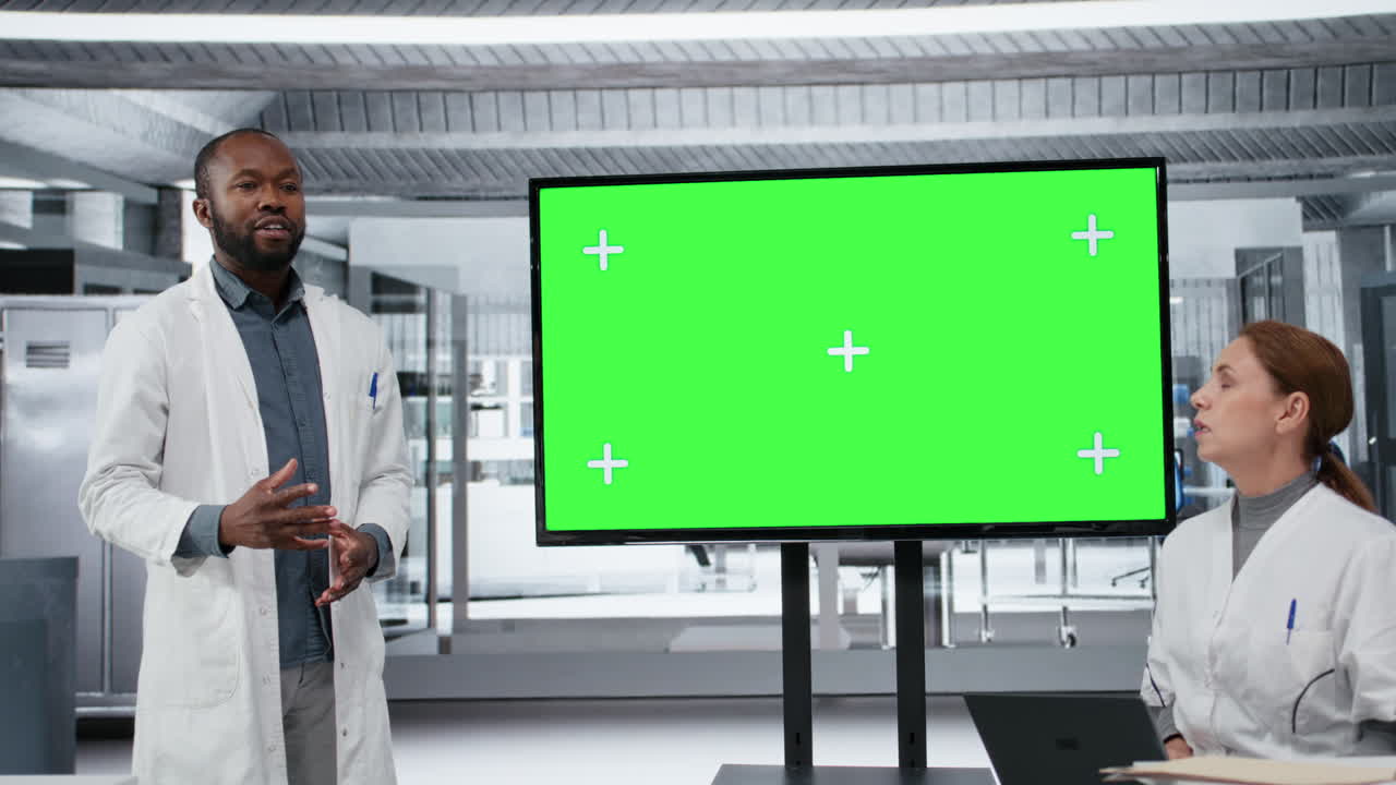 Chroma key display used by professor mentoring researchers during workshop