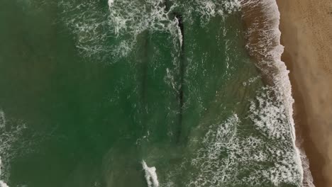 Waves-break-on-sandy-beach-shoreline