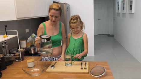 mom and daughter cooking together