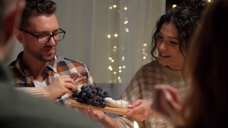 Feiertage-Und-Festkonzept-Glückliche-Freunde,-Die-Zu-Hause-Weihnachtsessen-Haben-Und-Essen