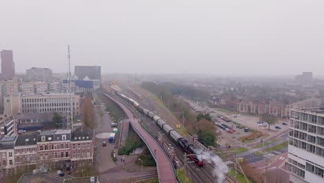 drone cinematic follow of steam engine entering nijmegen