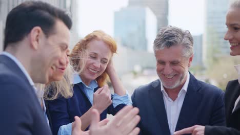 happy business professionals collaborating outdoors