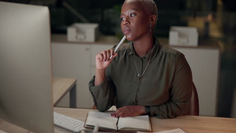 woman thinking at desk in office