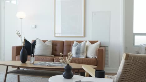 knee level rising shot of the living area in a high ceiling penthouse condominium unit focus from close to far during a sunny day