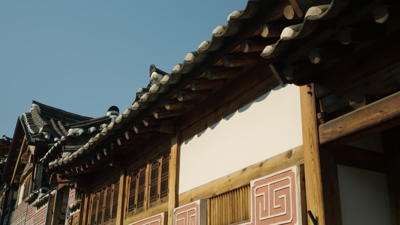 Wooden eaves and traditional tiled roof of a Korean Hanok house, showcasing exquisite historical architecture and craftsmanship - tuck left