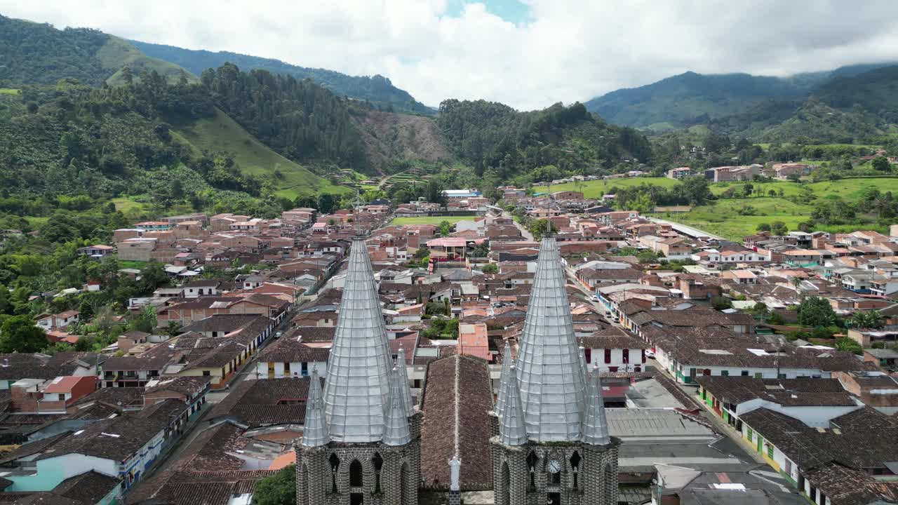 Aerial view of the idyllic Andean town of Jardín in Colombia, featuring the vibrant central square, the church Basílica Menor de la Inmaculada Concepción and the surrounding Andean mountain landscape