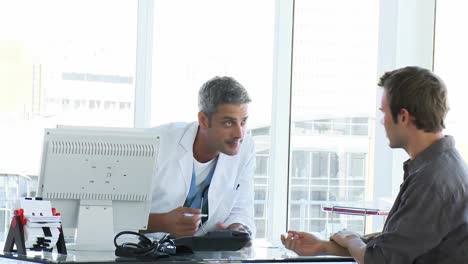 male doctor examining a patients arm