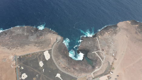 Atlantic-coast-on-Sal-Island,-Cape-Verde,-volcanic-stone-contrasting-with-the-Atlantic-Ocean