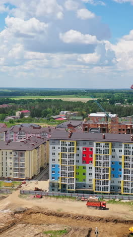 new construction site on nature background. high rise buildings in construction area. construction works in the outskirts of a city. vertical video