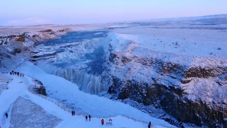 aerial view of frozen gullfoss waterfall in iceland with wild river