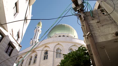 large islamic mosque with golden turrets in an islamic city in israel