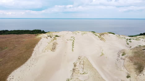 flying toward end of sandy dune with view to curonian lagoon