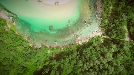 aerial view of people doing rafting surrounded by nature at soca river, slovenia