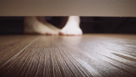 man and woman flirt stroking feet of each other on floor