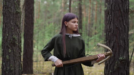 girl-with-crossbow-in-hands-walks-through