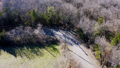 Aerial-Shot-of-Road-Cyclists-Taking-Turn-on-Long-Open-Road