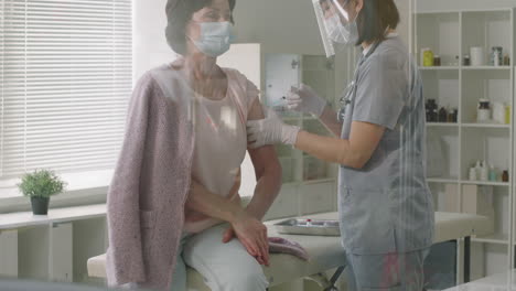 mature woman gets vaccinated against covid-19