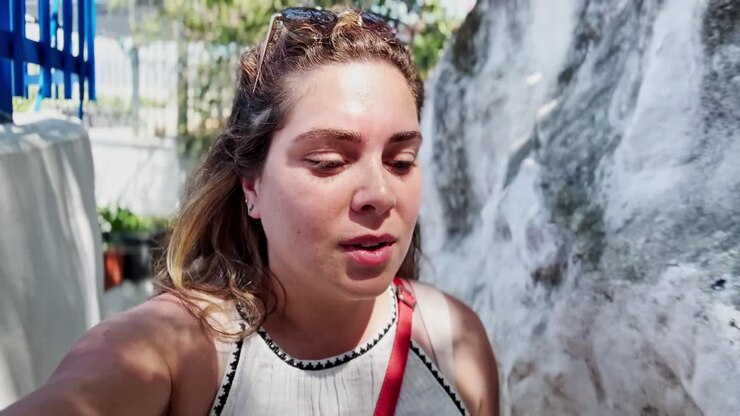 Glad kvinde vlogger på en solrig dag i Athen.