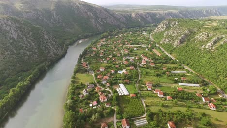 Una-Vista-Aérea-Muestra-El-Pueblo-De-Pocitelj-Bosnia-Y-El-Río-Neretva-Que-Corre-A-Lo-Largo