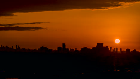 time lapse of a scenic, vibrant orange sunset against the mississauga, ontario city skyline silhouette