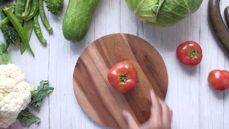 assortment of fresh vegetables on a wooden cutting board