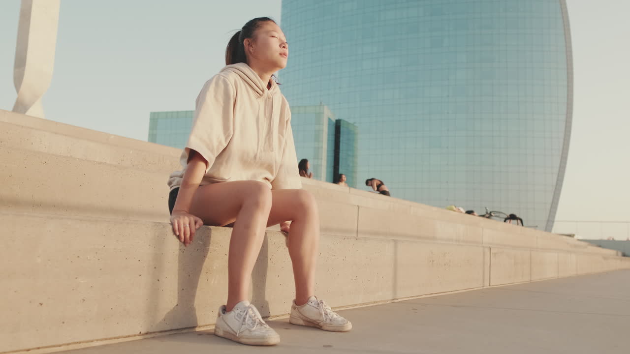 Woman relaxing on steps in the city