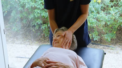 physiotherapist giving head massage to senior woman 4k