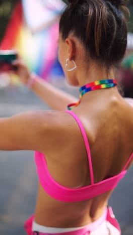woman at pride parade taking a selfie