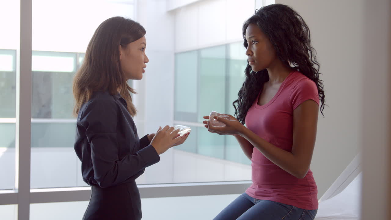 Breast Surgery Consultant With Female Patient In Office