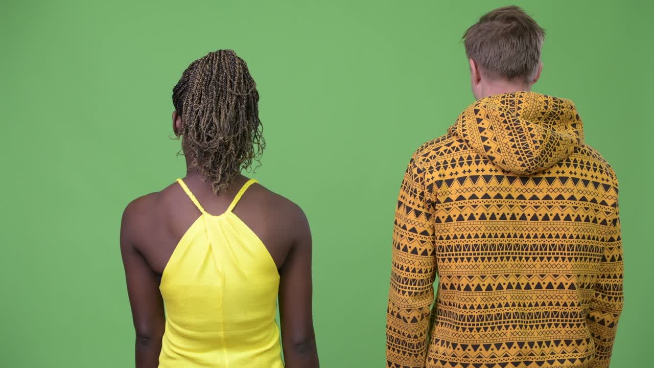 Young multi-ethnic couple with arms crossed together