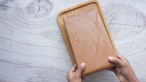 brown candy block on a wooden tray