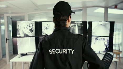 security guard monitoring security cameras in control room