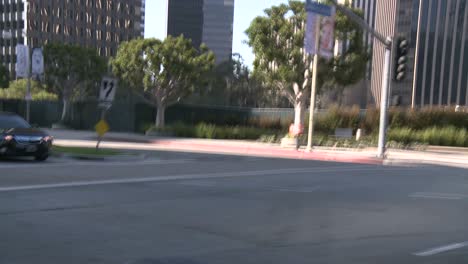 A-Car-Travels-Along-A-Street-In-Century-City-Los-Angeles-As-Seen-Through-The-Rear-Window-At-An-Angle-1