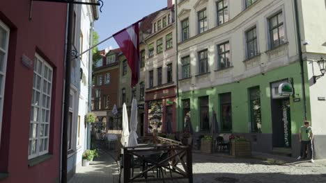 sunny day in a charming cobblestone street of riga, latvia