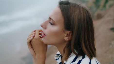 Closeup-girl-look-ocean-cliff-landscape-cliff-vertical.-Pensive-person-consider